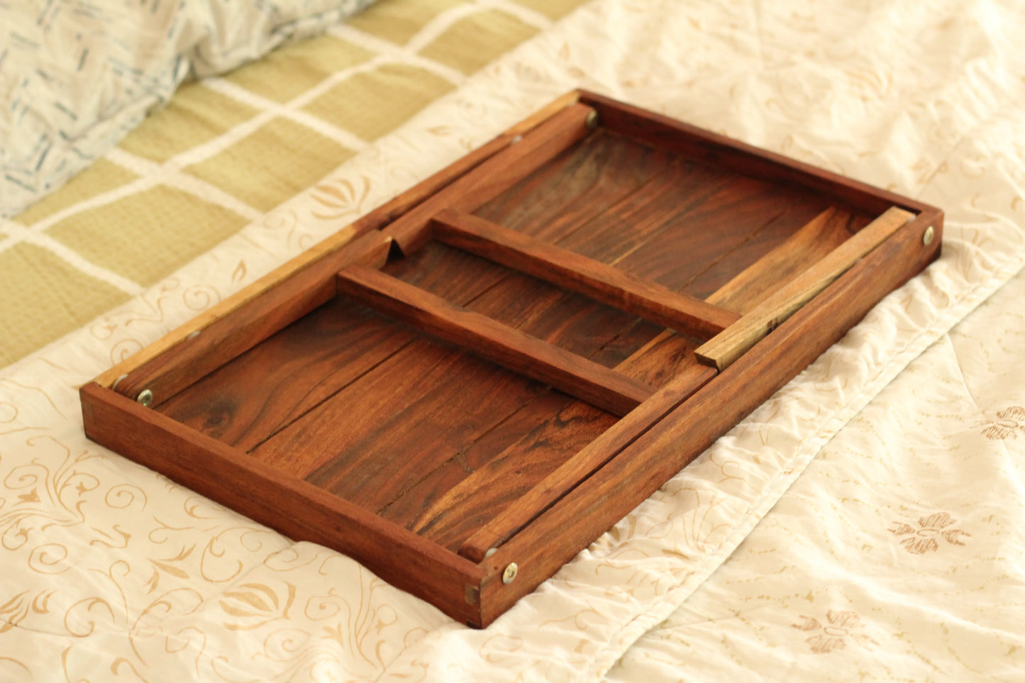 Foldable table styled on a balcony with a plant, journal, and a cup of tea.