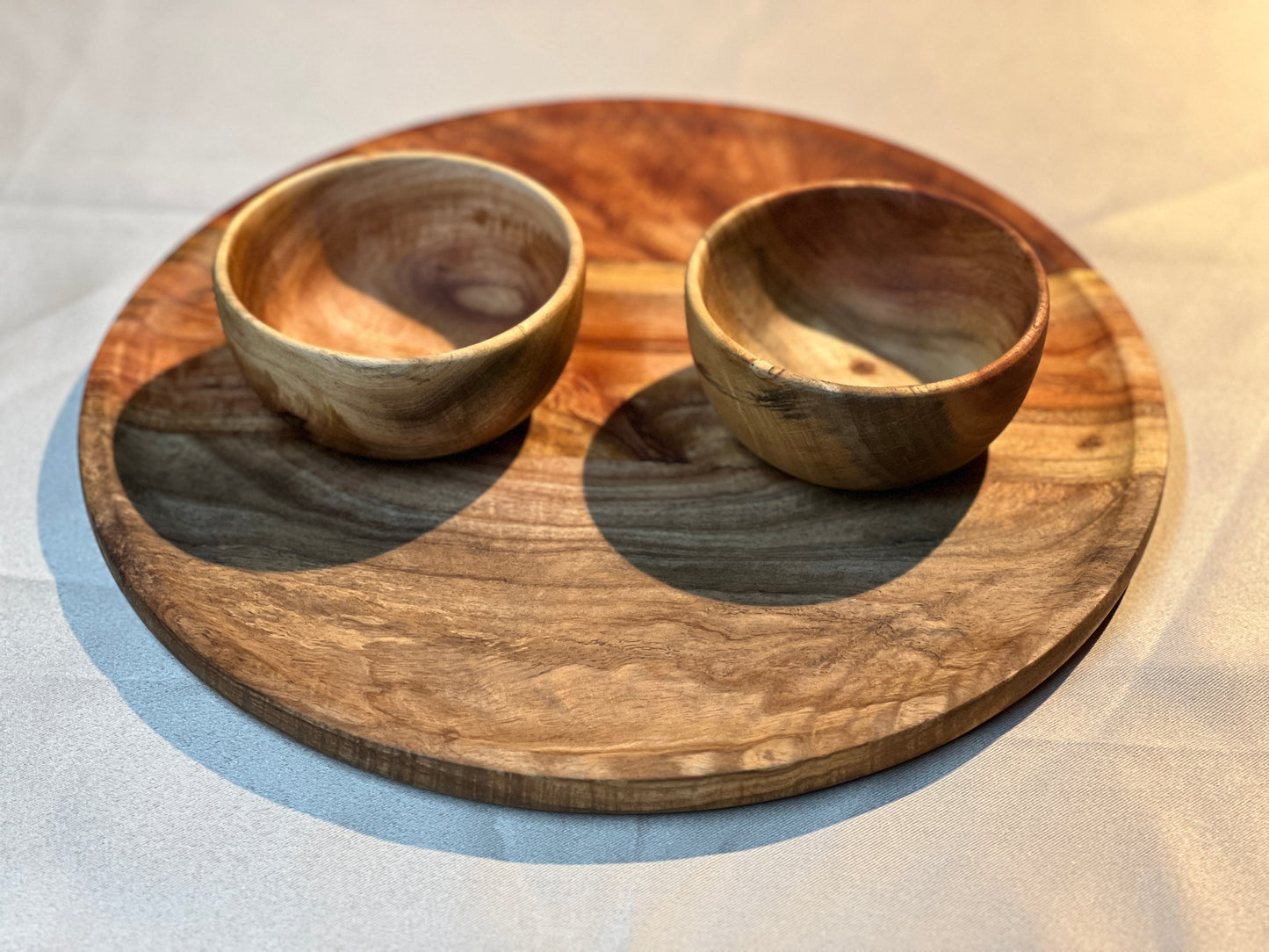 The bowls resting on the plate, highlighting the cohesive design and multipurpose usability.