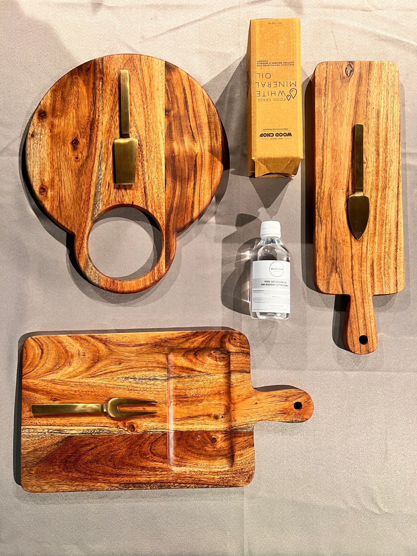 Top view of the Cozy Entertainer Gift Set with wooden trays, coasters, and boards styled for festive gifting.