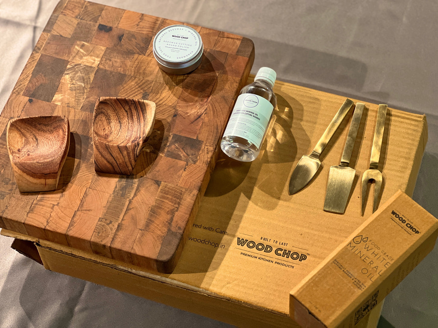 Lifestyle image of a chef unboxing the wooden gift set in a modern kitchen environment.