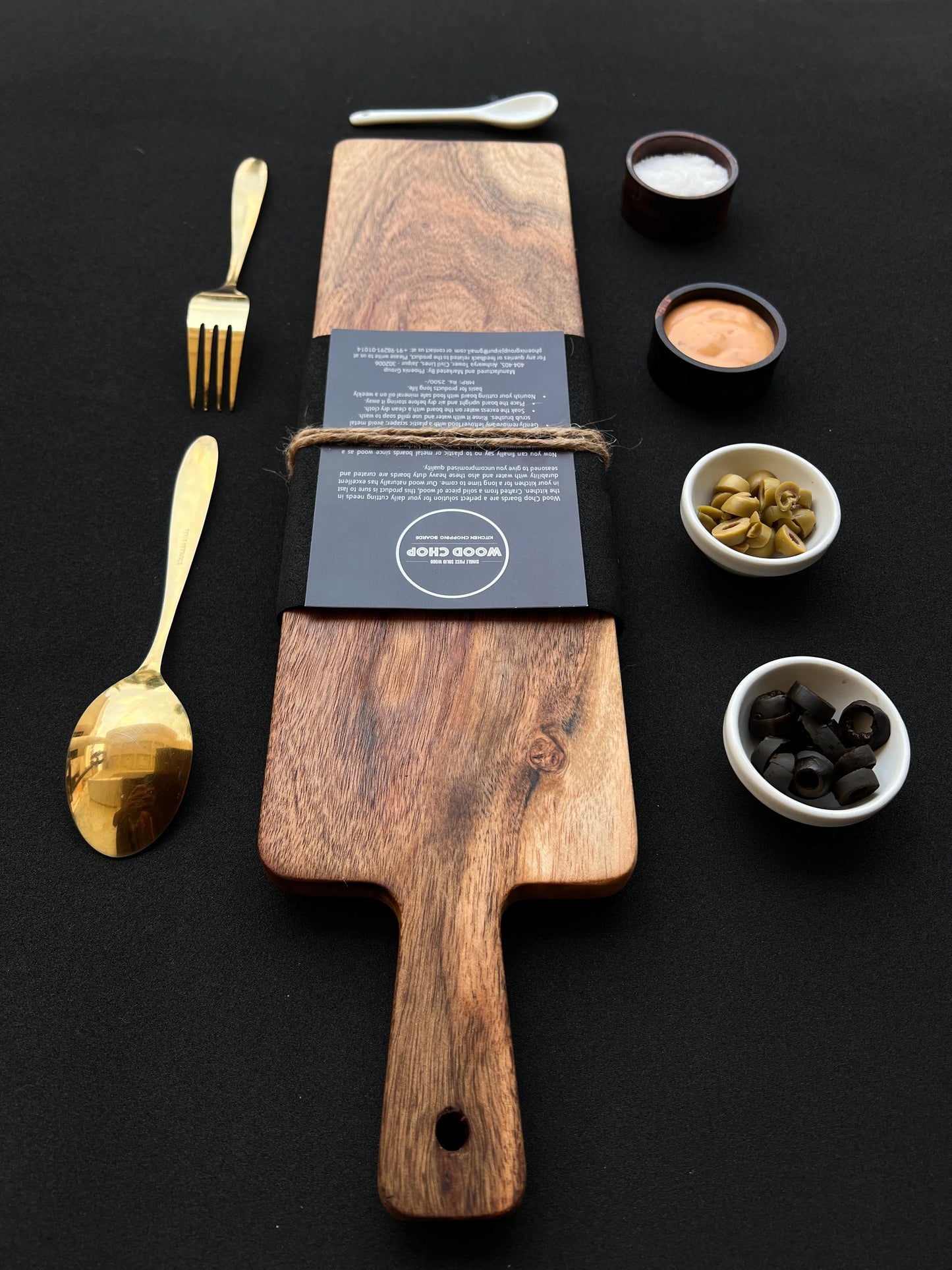 Cheese board styled with sliced cheese, olives, and crackers for a party spread.
