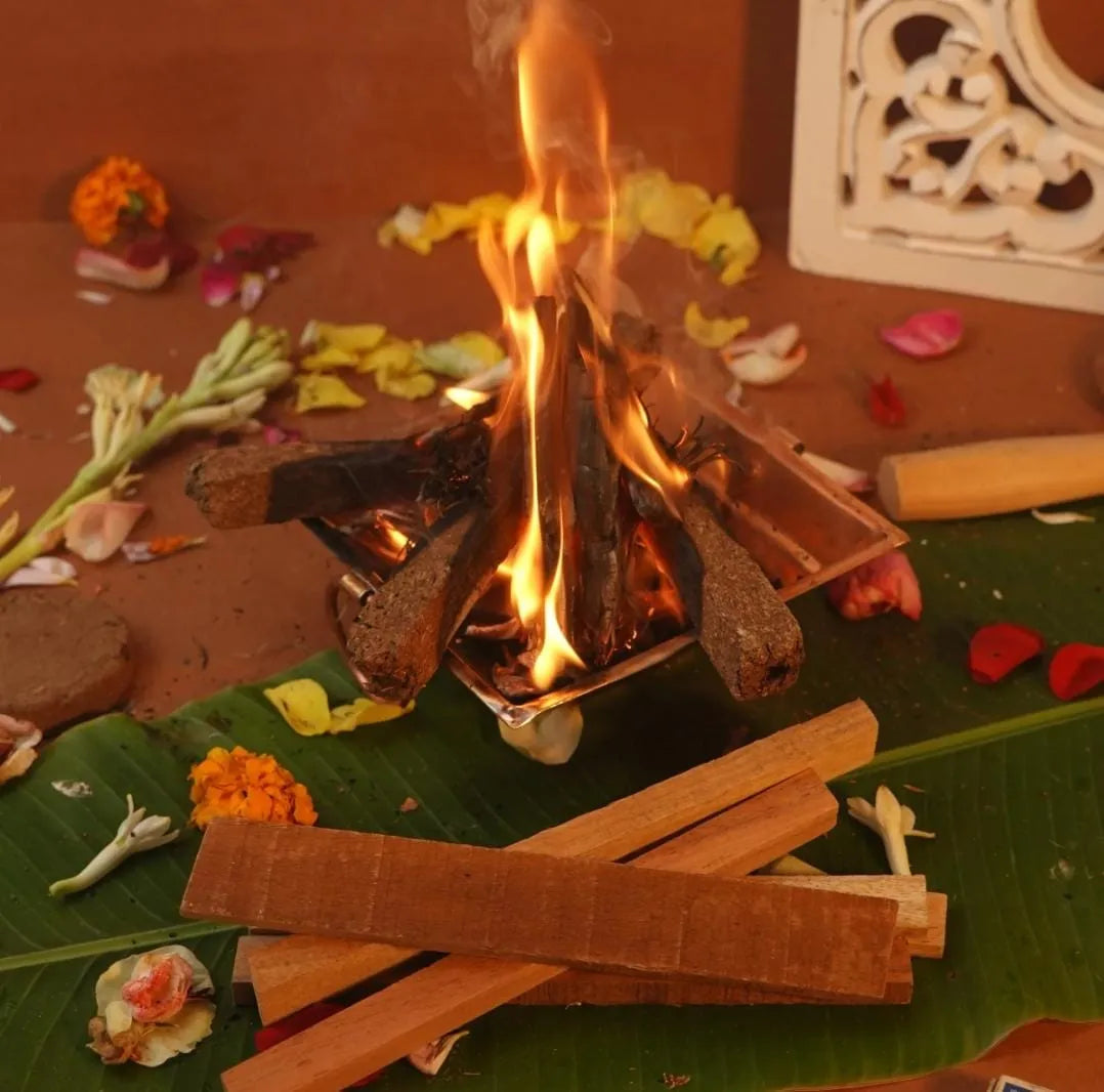 Mango wood sticks placed next to Hawan Kund setup, ready for a ritual or puja.