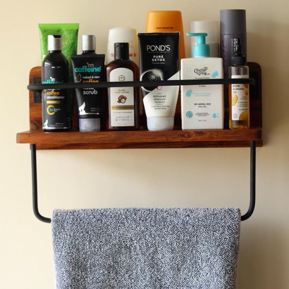 Front view of acacia wood wall rack mounted on a white wall, styled with jars and small decor items.