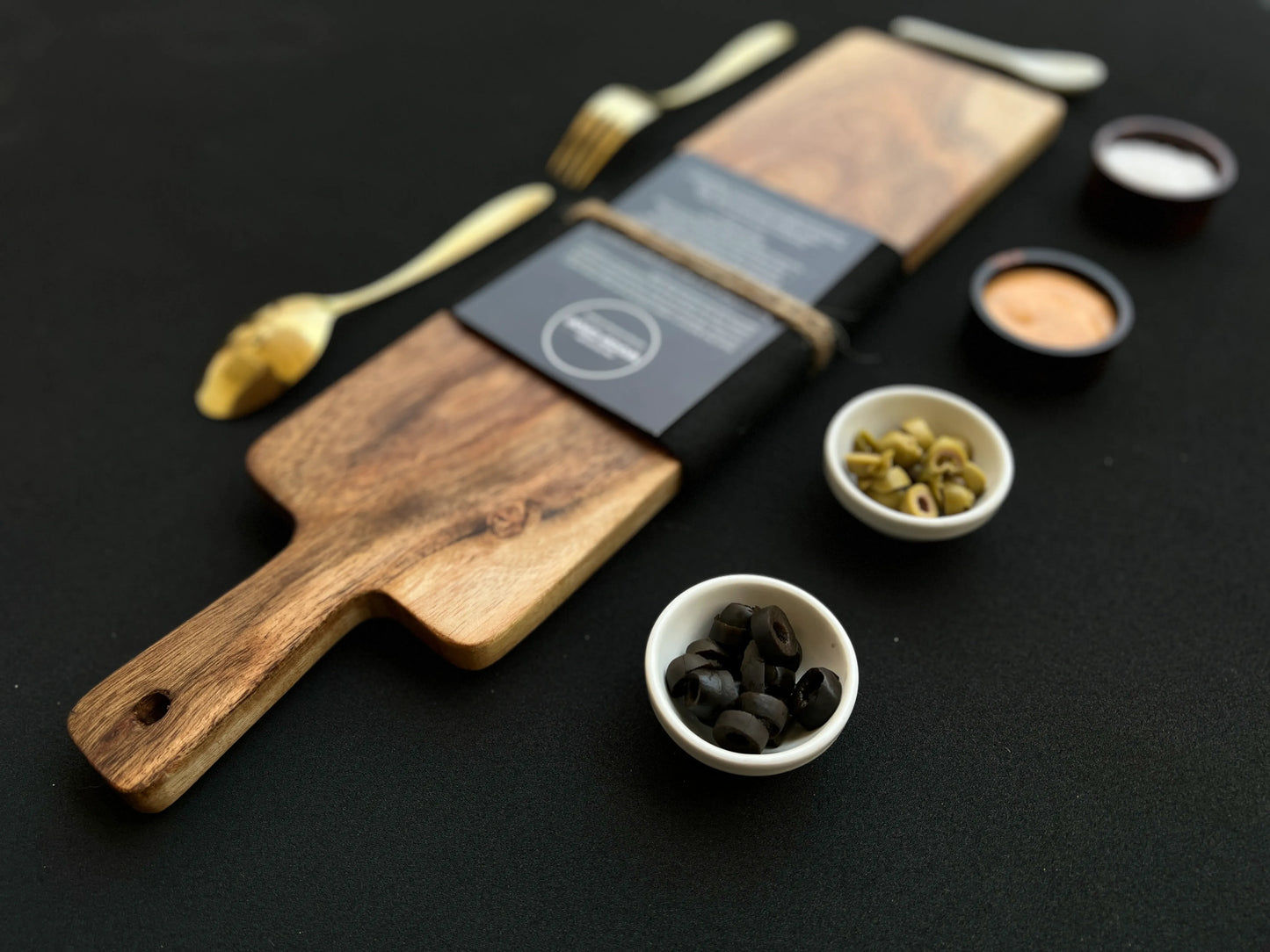 Board used for personal snacking setup with fruit and a glass of wine.