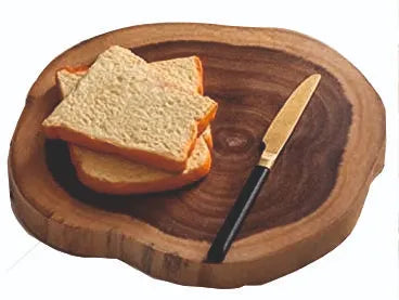 Live edge board used as a serving base for cheese and charcuterie.