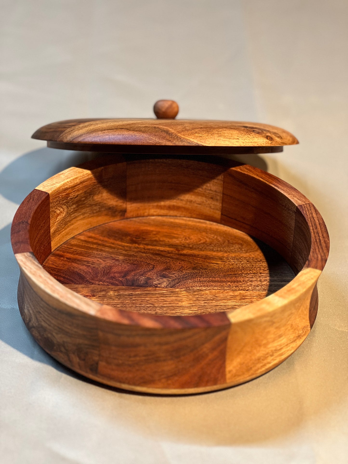 Side profile of the closed roti box on a kitchen counter, showcasing its round shape and smooth finish.