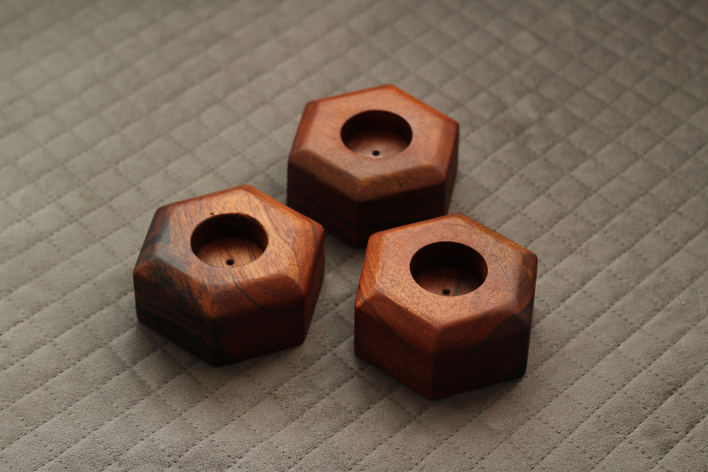 Candle holders placed on a shelf with lit candles, creating a warm and cozy ambiance.