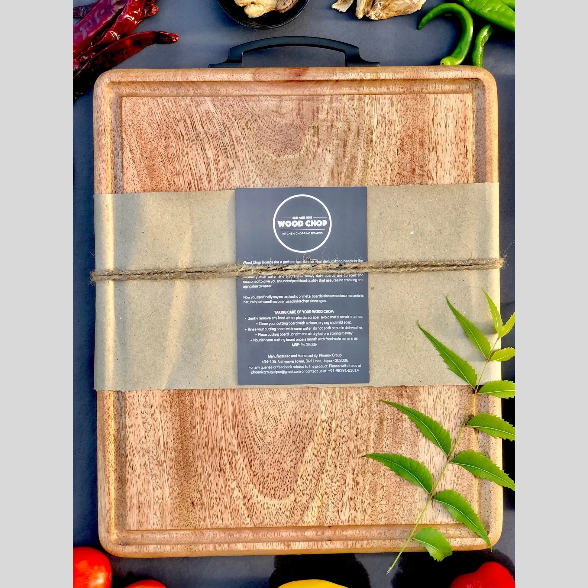 Top view of a 15x12 inch mango wood cutting board with a carved juice groove around the edge.