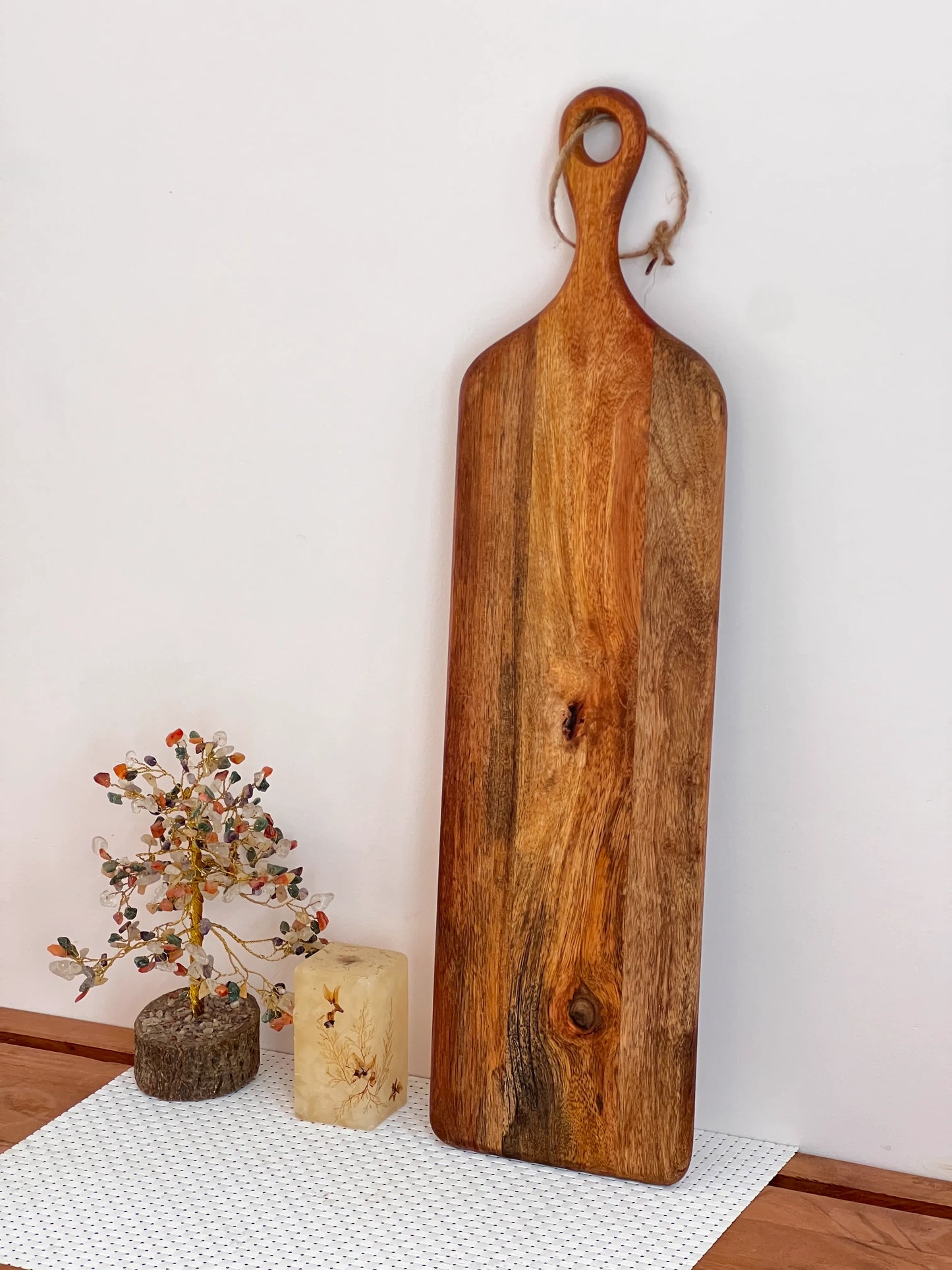 Serving board styled with crackers, cheese, and grapes for a charcuterie setup.