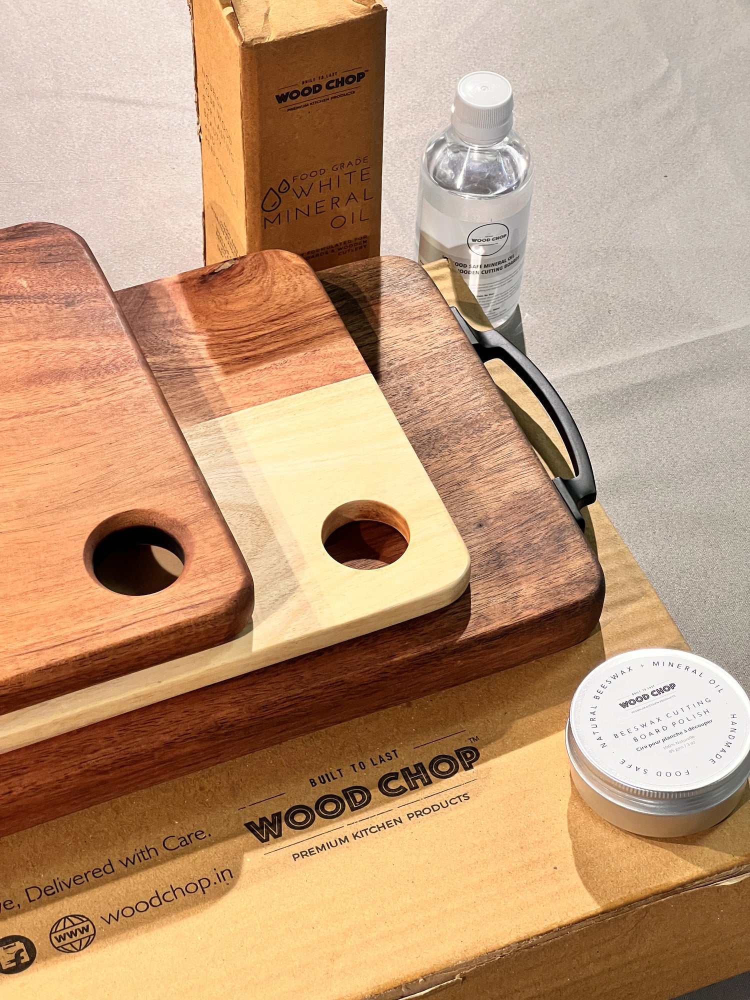 Top view of the 3-piece acacia wood chopping board set stacked on a countertop, showing varied sizes and wood grain patterns.