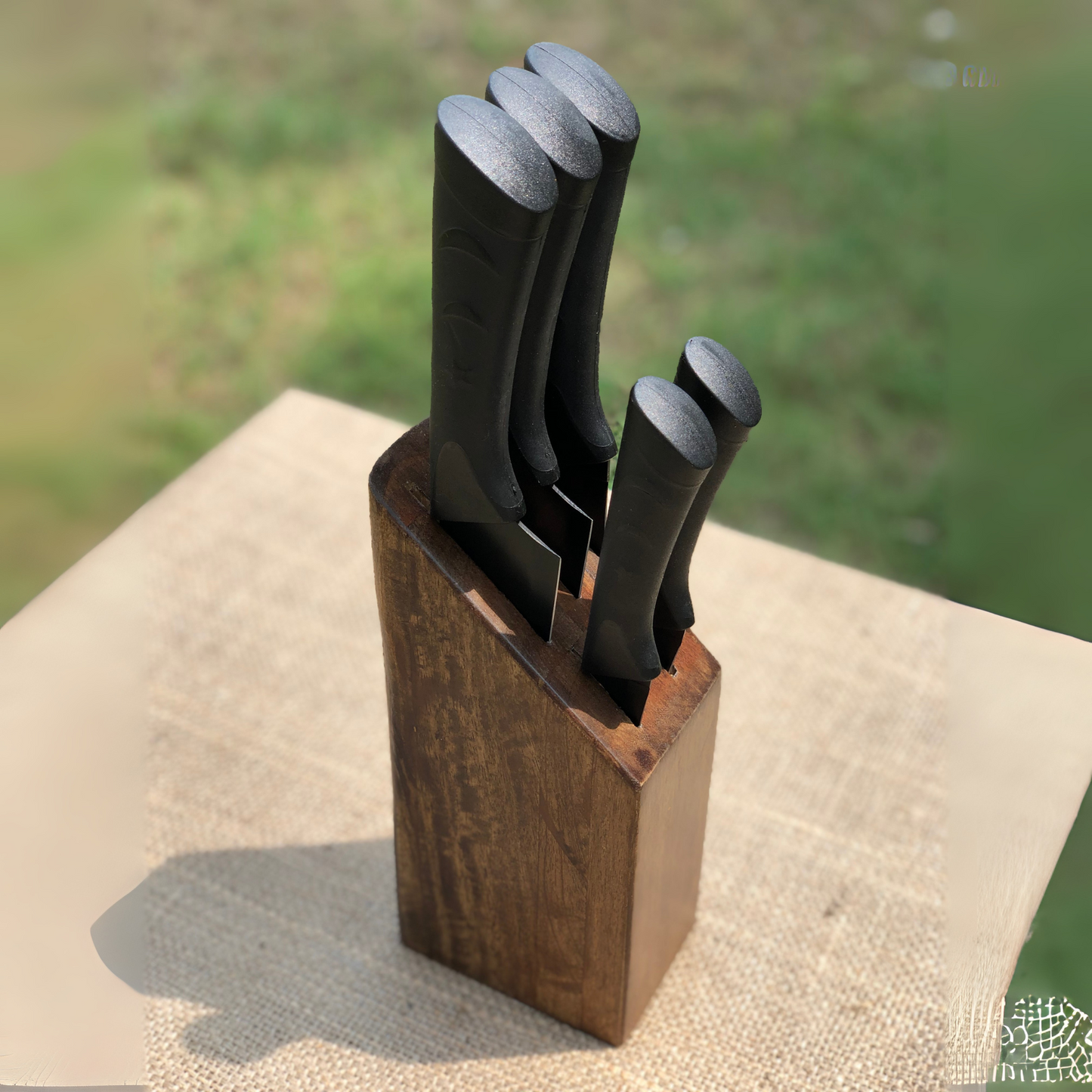 wooden block on a textured surface with a blurred natural background