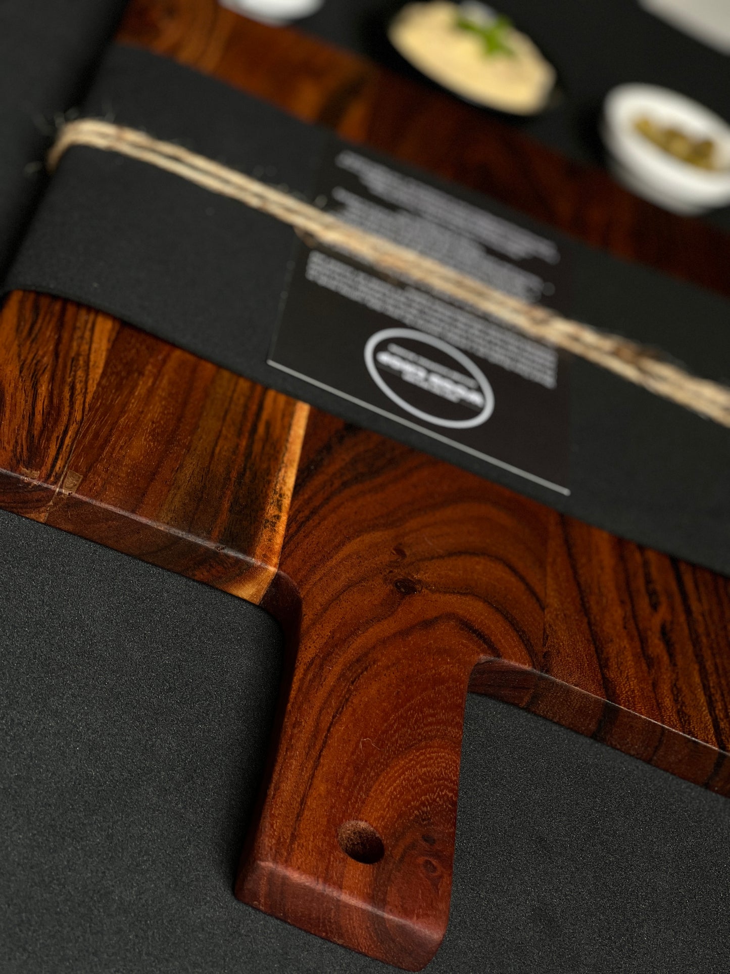 Lifestyle photo of the wooden board placed on a rustic kitchen counter with natural light.