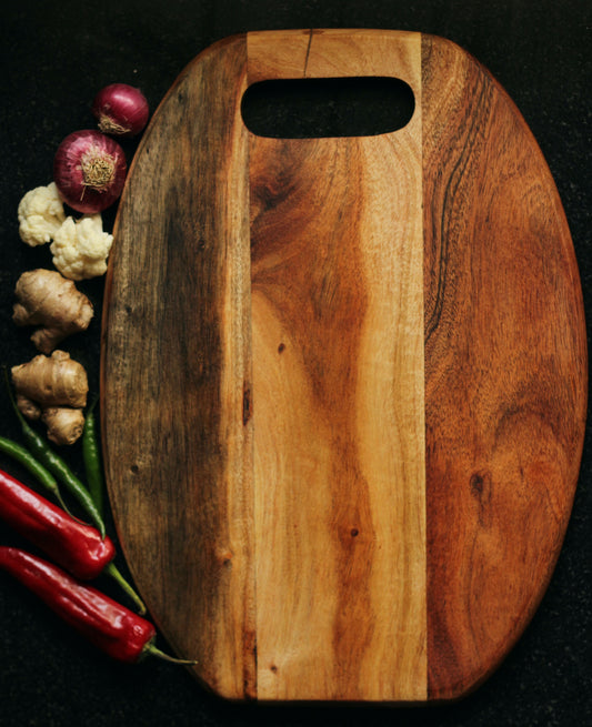  Top view of the 14.5 x 10.5 inch Acacia wood cutting board placed on a kitchen counter with fresh produce.