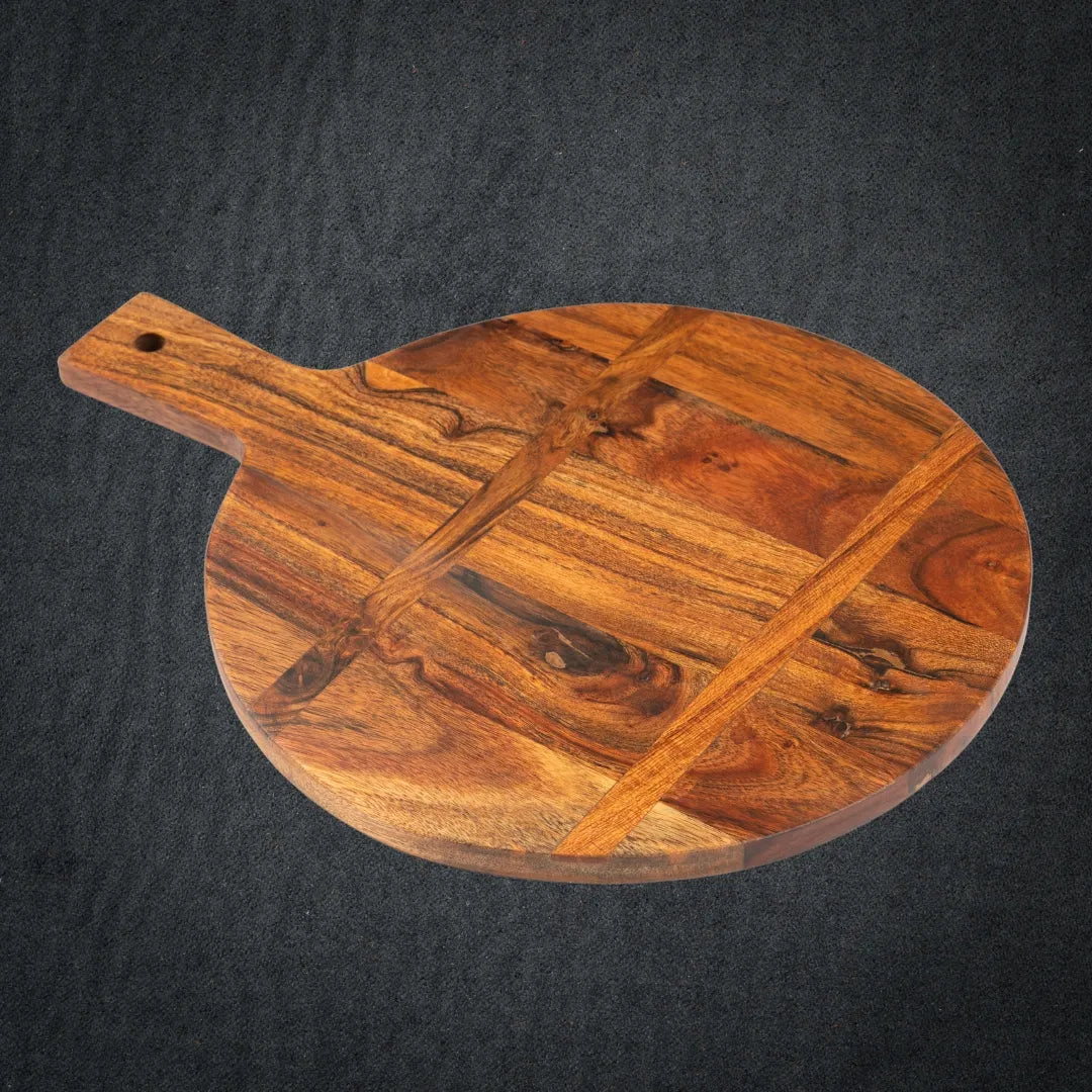  Acacia cutting board placed on a dining table with cheeses and wine.

