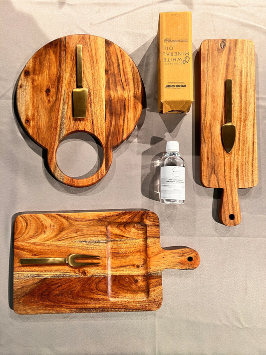 Top view of the Cozy Entertainer Gift Set with wooden trays, coasters, and boards styled for festive gifting.