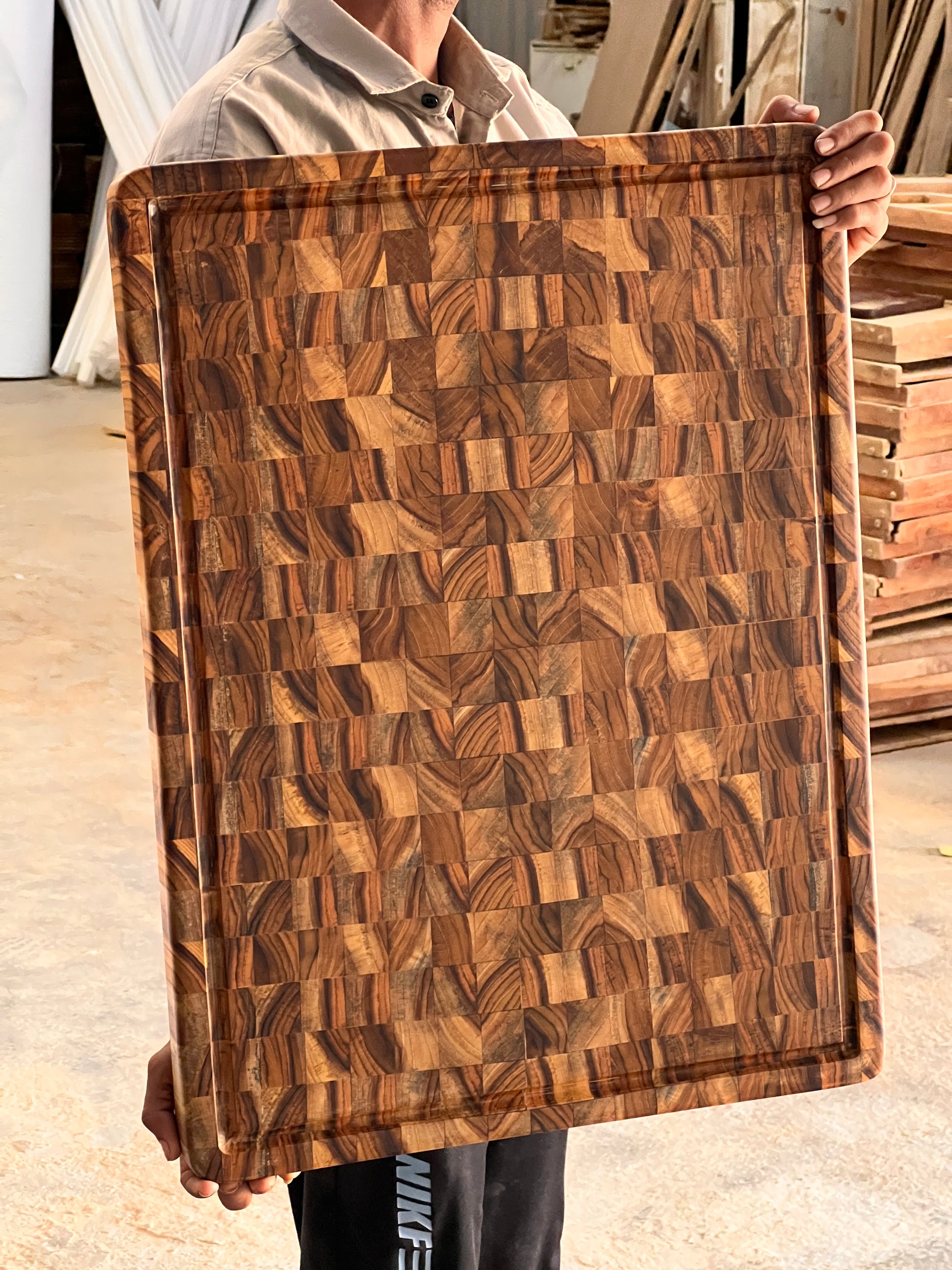  Lifestyle photo of custom cutting board in a kitchen setting, engraved with a family name.