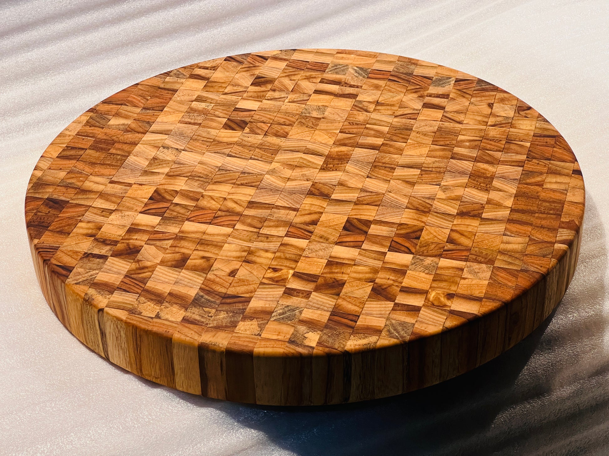 Custom board used as a serving platter for cheese and snacks, showcasing its multi-functionality.