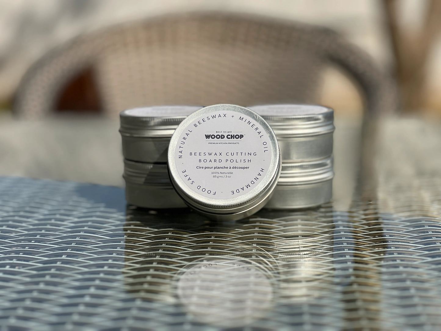 Close-up of solid beeswax polish in a tin, labeled as food-safe and natural.


