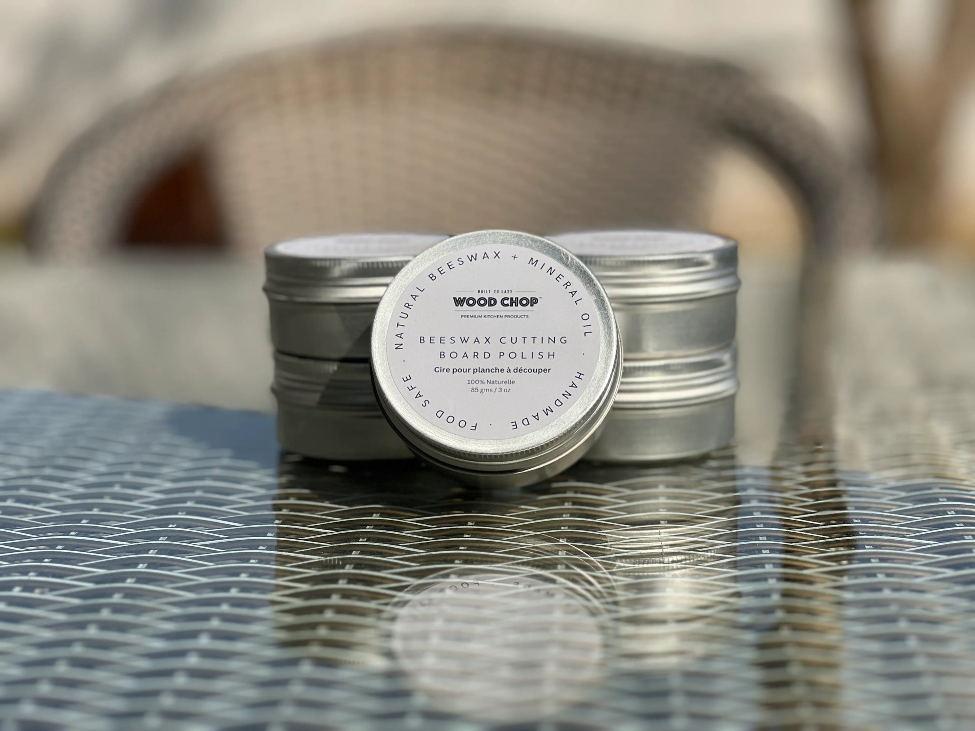 Close-up of solid beeswax polish in a tin, labeled as food-safe and natural.

