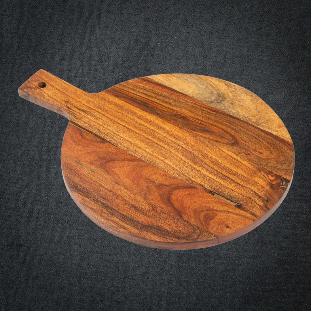 Close-up of rich acacia wood grain and rounded European design handle.