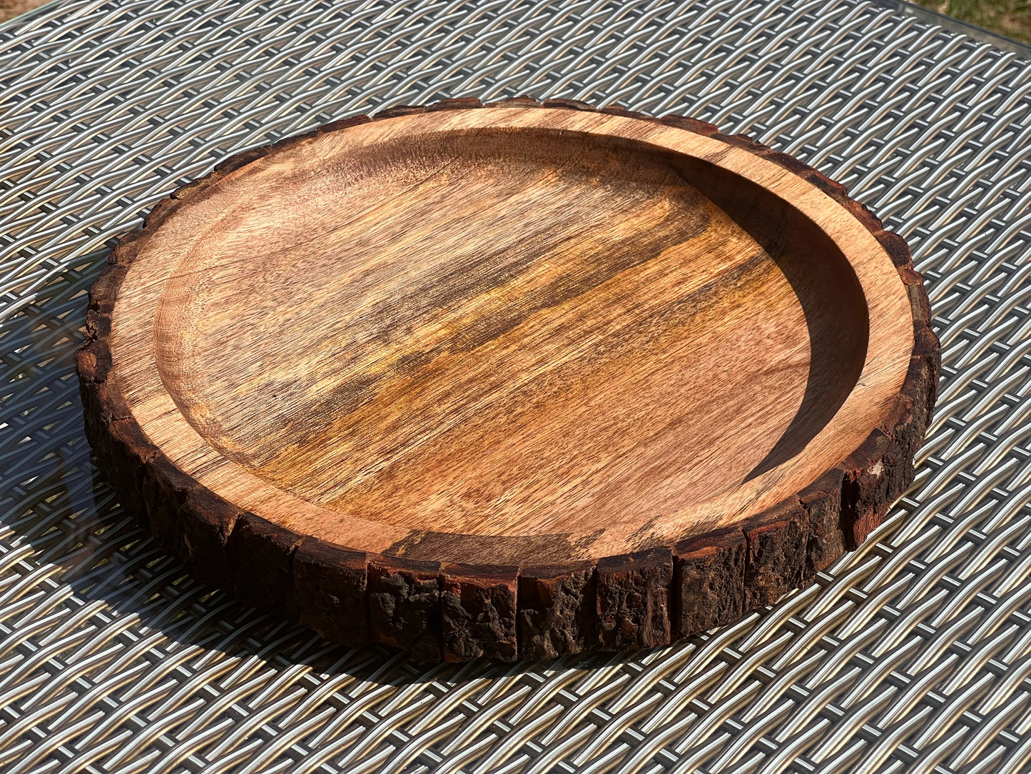 Top view of a 12-inch round mango wood tray with a natural live edge design.