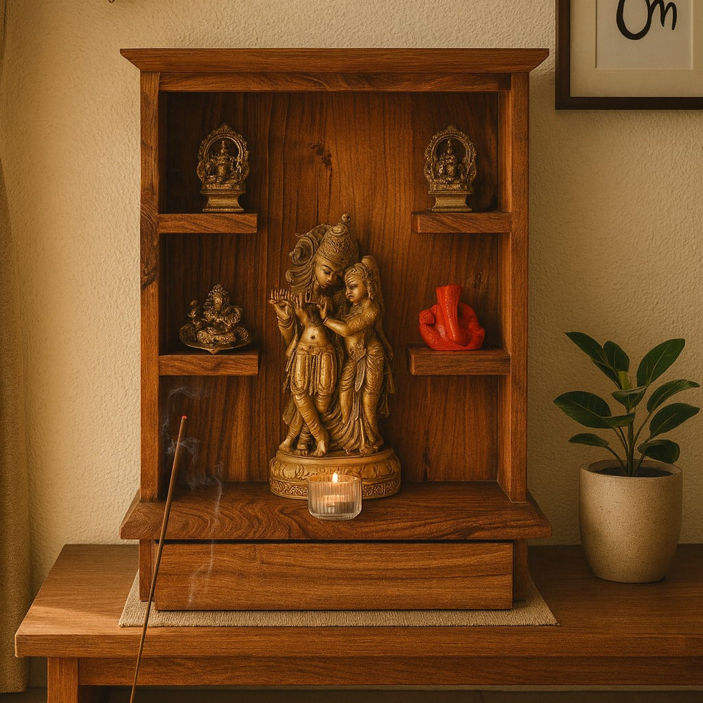 Wooden altar with religious statues and a candle, surrounded by a plant and framed picture.