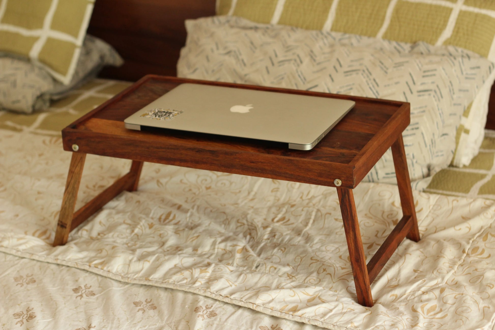 Lap table used as a breakfast tray with coffee, a plate, and cutlery setup.