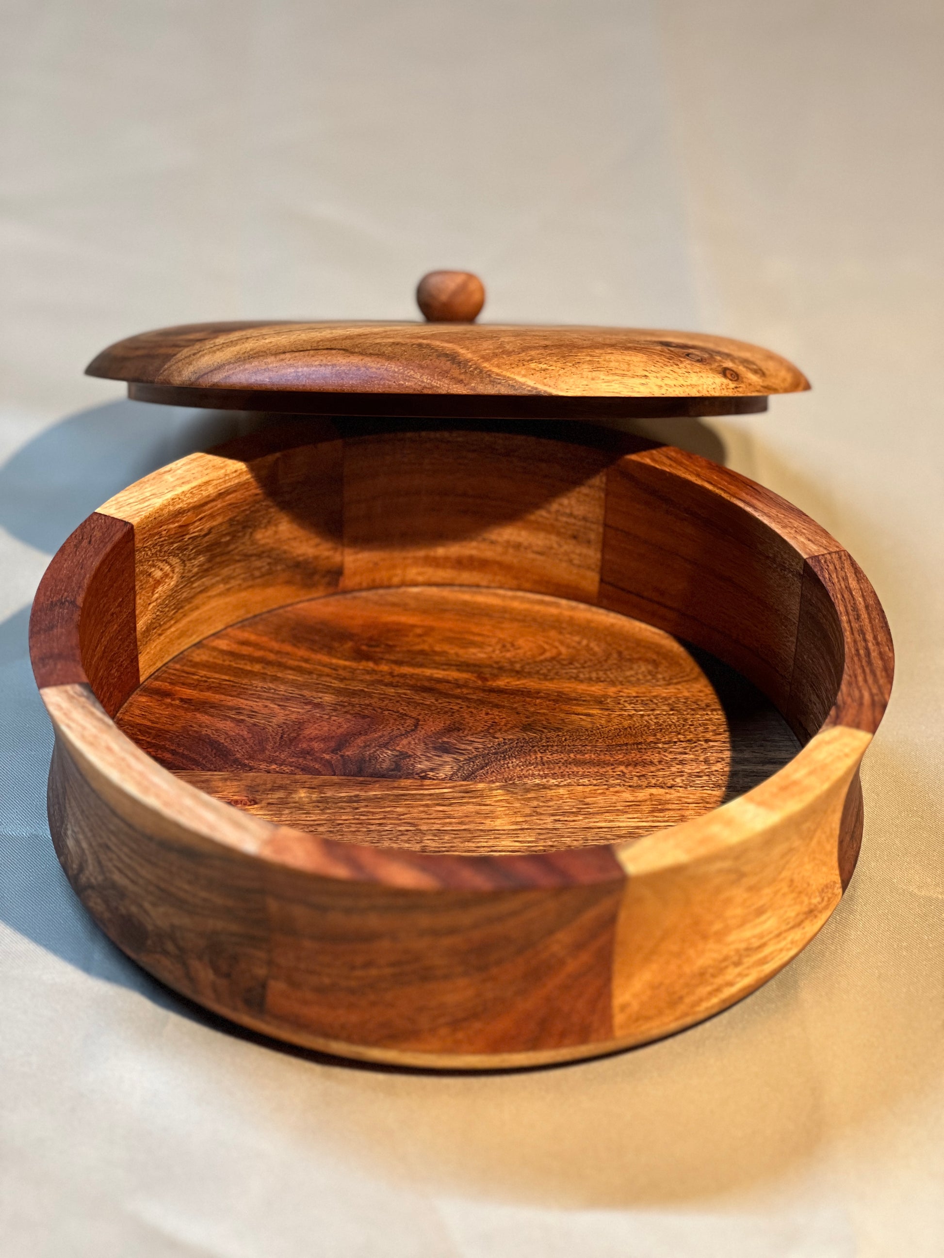 Side profile of the closed roti box on a kitchen counter, showcasing its round shape and smooth finish.