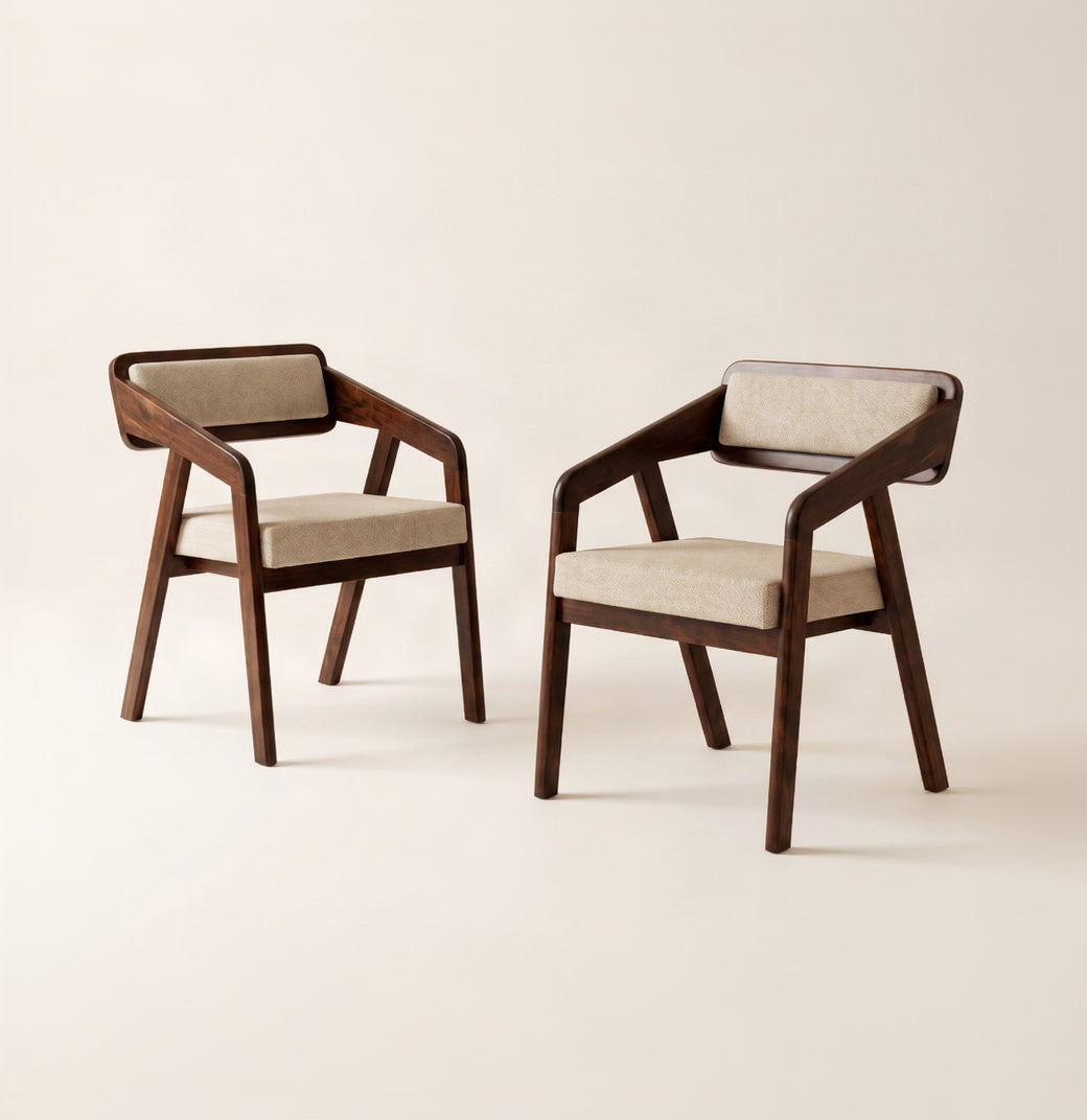 Two modern armchairs with dark brown wooden frames and light beige upholstered seats and backrests, shown on a clean off-white studio background.