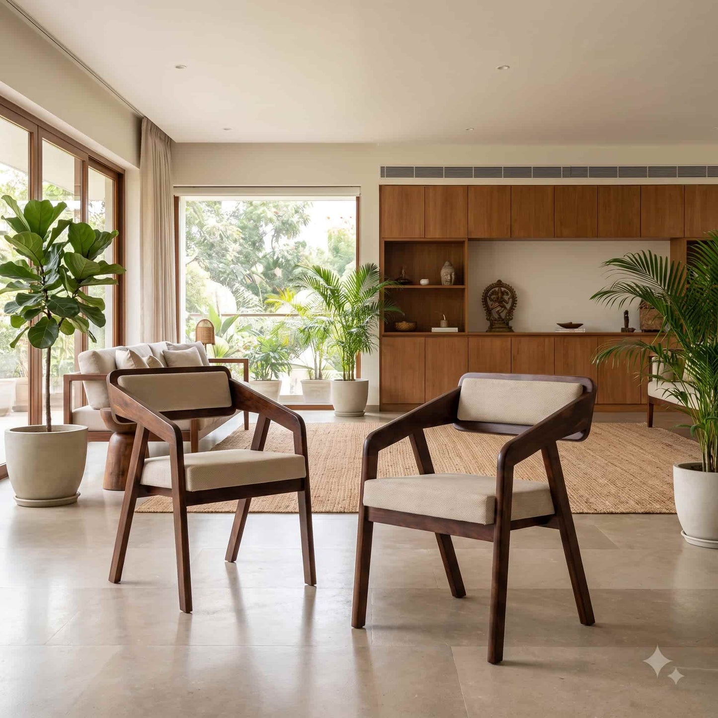 Two mid-century modern armchairs with dark wood frames and cream cushions, arranged in a bright, contemporary living room with plants and a wooden cabinet in the background.