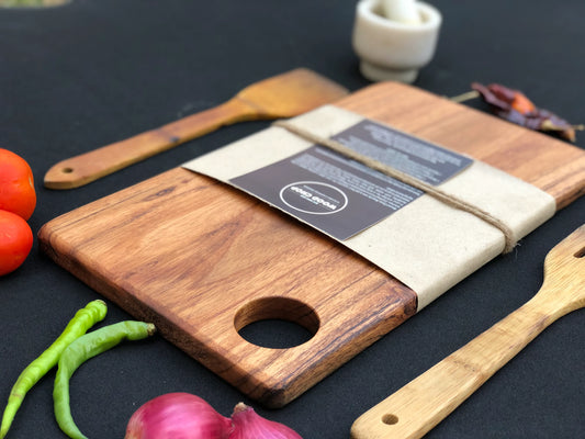 Top view of a single-piece acacia wood cutting board with beautiful natural grain.

