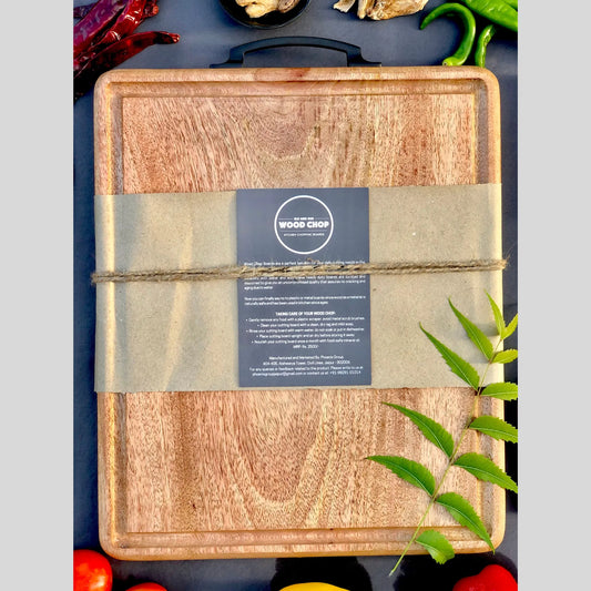 Top view of a 15x12 inch mango wood cutting board with a carved juice groove around the edge.