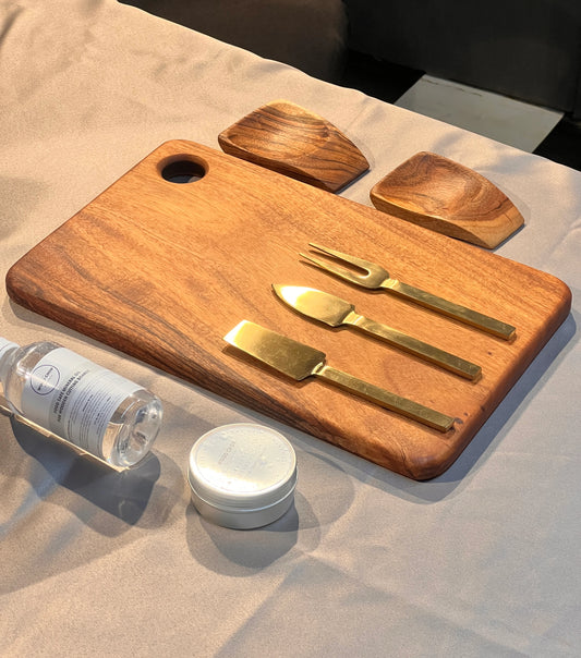 Top view of The Ultimate Kitchen Gift Set including chopping boards, spoon rest, coasters, and wooden utensils neatly arranged.