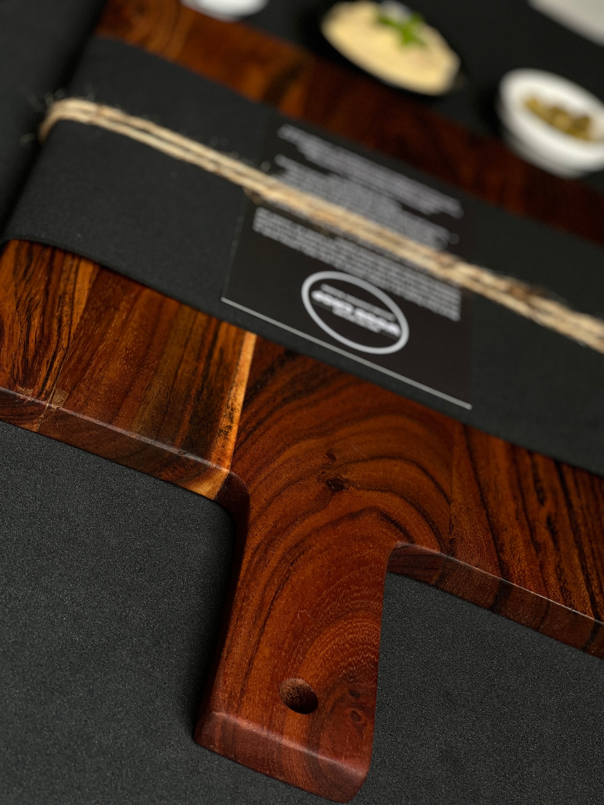  Lifestyle photo of the wooden board placed on a rustic kitchen counter with natural light.